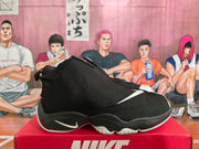 Side profile of a black Nike high-top sneaker with a covered upper, white Swoosh detail, and sculpted outsole.