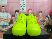 Front view of the fluorescent green sneakers showing the paired toe boxes, tonal laces, padded tongues, and rounded forefoot design.