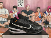 Side profile of black and white basketball sneakers with textured uppers, white Swoosh branding, and dark outsoles.