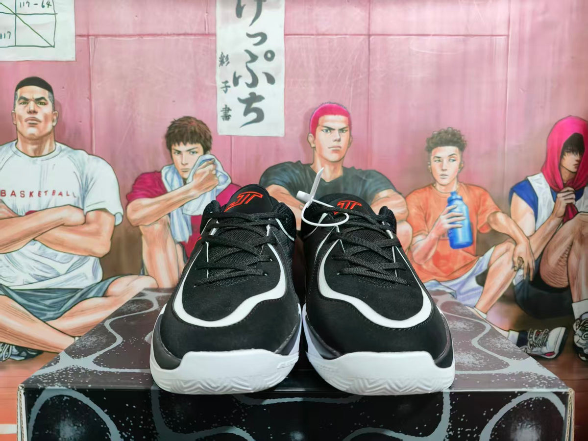 Front view of black basketball sneakers with white curved overlays, red tongue branding, and white textured outsoles.