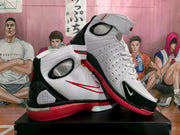 Angled view showing the padded ankle collars, perforated white side panels, black overlays, and red side logos.