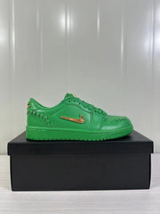 Side profile of a green low-top sneaker with a metallic gold Swoosh and textured green outsole.