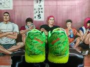 Rear view of the sneakers showing red TWELVE lettering on both heels and the textured neon outsole.