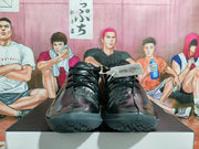 Front view of black lace-up basketball shoes with textured outsoles