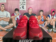 Front view of red Nike Air Max Dn sneakers showing the laces, textured uppers, and glossy toe overlays.
