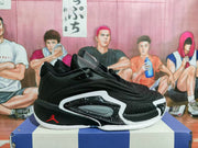 Side view of a black Jordan basketball shoe with layered panels and white and red accents