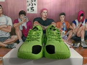 Front view showing the green lace-up upper, black toe accents and padded collars.