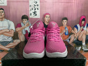 Front view of pink basketball sneakers with textured uppers, pink laces, white midsoles, and Kobe-related tongue logos.