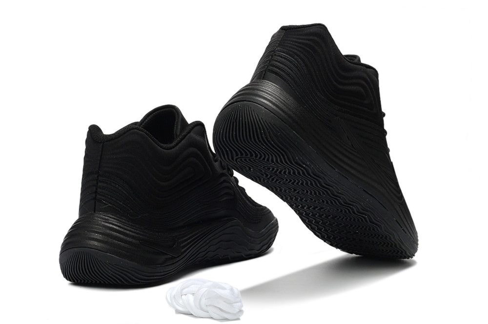 Pair of all-black Nike Precision 8 basketball shoes shown from an angled rear and outsole view.