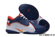 Navy blue, white, and red Nike LeBron 22 sneakers with contrasting dark blue outsoles.