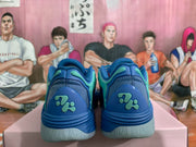 Rear view of blue Puma sneakers showing the heel branding, padded collars and light-colored outsoles.