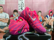 Angled side view of pink and purple Nike basketball shoes with contrasting Swoosh logos