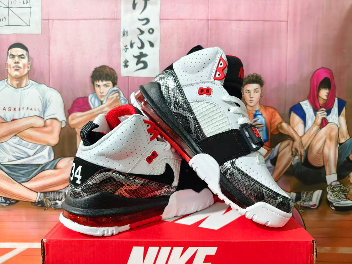 White, black, and red Nike high-top basketball shoes shown from the side with patterned overlays and heel Air units.