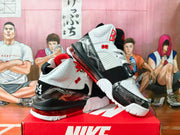 White, black, and red Nike high-top basketball shoes shown from the side with patterned overlays and heel Air units.