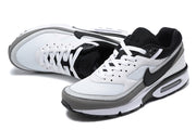 Pair of white, black, and grey Nike Air Max sneakers shown from above and at an angle.