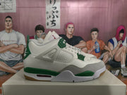 Side view of a white and green sneaker showing gray overlays, mesh side panel, green midsole accents, and a visible air-unit window.