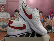 Displayed pair of white and red Nike low-top sneakers resting on a shoebox.
