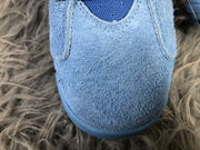 Close-up view of the textured sky blue toe box and stitched paneling.