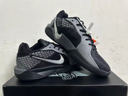 Pair of black and grey Nike Kobe basketball shoes displayed together