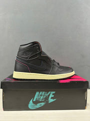 Side profile of the black high-top sneaker showing the perforated toe box, Swoosh and winged ankle emblem.