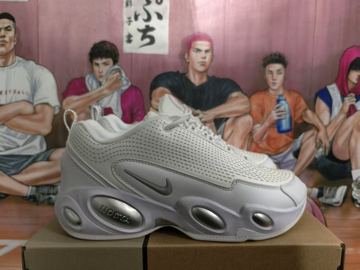 Side view of white Nike sneakers showing the perforated upper, Swoosh, and sculpted cushioned sole.