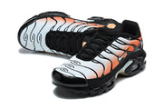 Pair of black, white, and orange Nike Air Max Plus sneakers from front and side angles