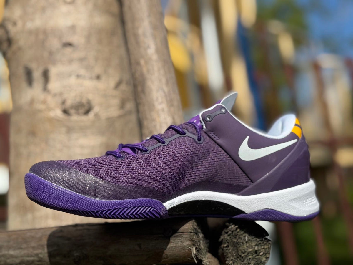 Purple Nike Kobe 8 basketball shoe with a white side Swoosh and white midsole.