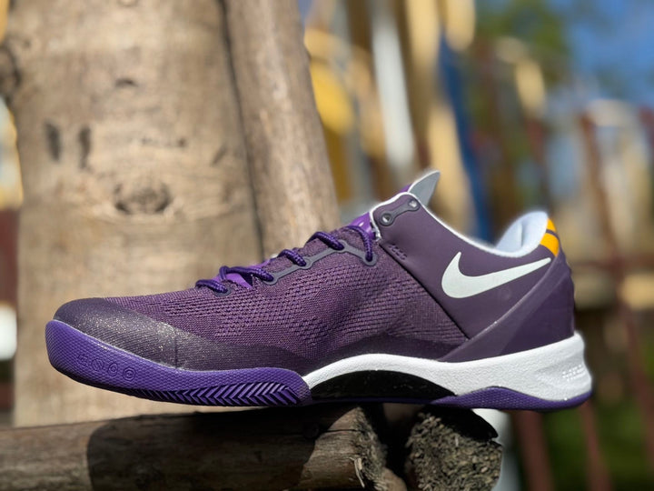 Purple Nike Kobe 8 basketball shoe with a white side Swoosh and white midsole.