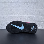 Outsole view of a black Nike sneaker with a light-colored swoosh