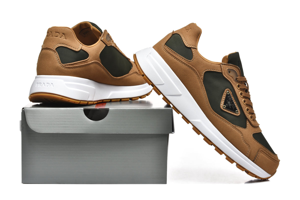 Pair of brown and dark green-black Prada low-top sneakers displayed with a shoe box.