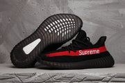 Black sneaker shown beside its outsole, displaying the ribbed dark sole and textured tread.