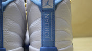 Rear view showing the blue Jordan heel pull tab and stitched panels.