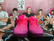 Front view of pink and purple Nike basketball shoes with laces and patterned uppers