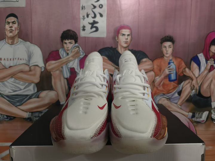 Front view of white and red Nike basketball sneakers displayed on a shoebox.