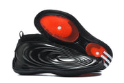 Side and outsole view showing the sculpted upper, textured tread, and red circular outsole sections.