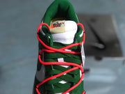 Top-down view of the green tongue, green laces, and bright red cord-style laces.