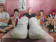 Front view of the white sneakers with lace-up closure
