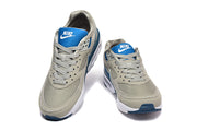 Front view of gray Nike Air Max sneakers with blue tongue labels.