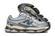 Blue-gray New Balance sneaker with the outsole of the second shoe visible.