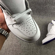 Close-up of the perforated white toe box and white laces.