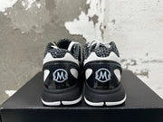 Rear view of black and white Nike basketball shoes with patterned collars and heel details