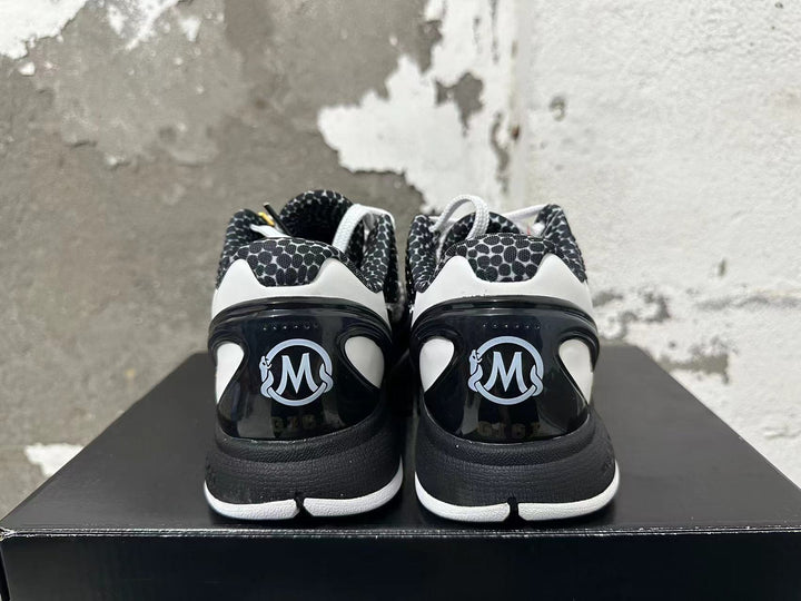 Rear view of black and white Nike basketball shoes with patterned collars and heel details