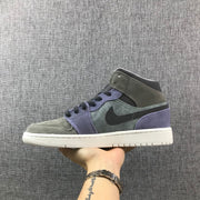 Profile view of one mid-top sneaker showing the contrast Swoosh and layered panels.