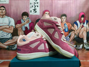 Pair of pink and burgundy low-top adidas sneakers shown from the side