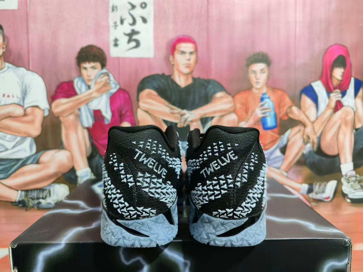 Rear view of black and gray Nike basketball shoes with patterned uppers and heel lettering reading TWELVE