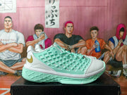 Side profile of a mint green and white basketball sneaker with a gold Nike Swoosh and textured midsole and outsole.