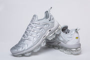 Silver-gray Nike TN-4 sneakers shown from front and rear angles