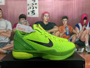 Side profile of a lime green Nike basketball sneaker with a black Swoosh, textured upper, and layered green sole.