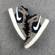 Top-down view of the pair showing leopard-print overlays, black panels, white Swooshes, and white outsoles.