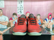 Front view showing red laces, textured red toe boxes, black trim, and translucent outsoles.